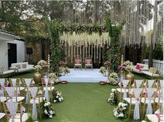 an outdoor ceremony setup with white and pink flowers