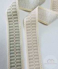 a close up of a ribbon on a white surface with an image of the side of it