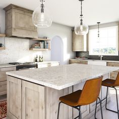 a kitchen island with three chairs in front of it