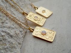 We're so excited to introduce my new line of high quality, anti-tarnish, waterproof jewelry. Thanks to our special plating technique, this celestial beauty is built to last, both pendant and chain are anti tarnish and waterproof. Crafted with hypoallergenic 18k gold stainless steel, it's lead and nickel free and safe and comfortable for sensitive skin. Your choice of pendants feature three of my favorite Major Arcana cards and a sweet little faux opal cabochon for an added touch of mystery. Choo Celestial Stainless Steel Jewelry For Gifts, Celestial Gold Jewelry With Rectangular Pendant, Gold Celestial Jewelry With Rectangular Pendant, Nickel-free Celestial Stainless Steel Jewelry, Celestial Stainless Steel Nickel-free Jewelry, Celestial Style Tarnish Resistant Necklace As Gift, Celestial Stainless Steel Necklaces As Gift, Celestial Tarnish-resistant Necklace As Gift, Celestial Stainless Steel Necklace For Gifting