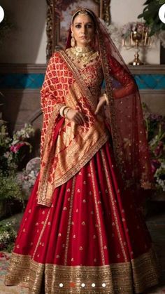 a woman in a red and gold bridal gown