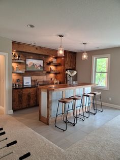 a kitchen with three bar stools in it