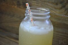 a mason jar filled with liquid and two straws