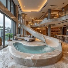 an indoor swimming pool with a slide in the middle and stairs leading up to it