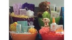 two stuffed animals sitting next to each other in front of baskets filled with toys and gifts