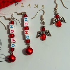 Handmade Christmas Pierced Dangle Earrings, Set Of 2. Ho Ho Alphabet Squares And Red Seed Beads Drop Earrings Angels Are Out Of Pretty Tiny Red Beads And Tiny Silver Tone Wings A Great Addition To Your Wardrobe For The Holidays By Hitting Buy Now You Could Purchase Them Today! Or Bundle Them With Other Items And I Will Send You A Discounted Price And You Save On Shipping! Christmas Jewelry Diy Earrings, Red Jewelry For Christmas Holiday, Diy Christmas Earrings Easy, Red Holiday Earrings With Ear Wire, Holiday Red Ear Wire Earrings, Red Dangle Earrings For Christmas, Red Dangle Jewelry For Christmas, Red Earrings For Valentine's Day Holiday, Red Ear Wire Earrings For Holiday