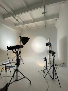 two photography equipment are set up in an empty room