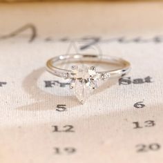 a close up of a ring on top of a sheet of paper with numbers in the background