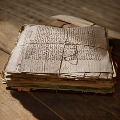 an old book sitting on top of a wooden table