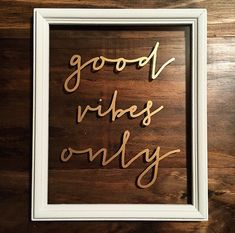 the words good vibes only are spelled in cursive wood