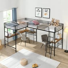 a loft bed with desk and chairs in the corner, next to a teddy bear