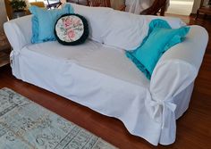 a white couch with blue pillows on it