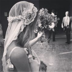 a woman in a wedding dress holding flowers