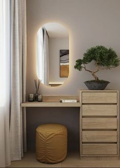 a small bonsai tree in a pot on top of a dresser next to a mirror