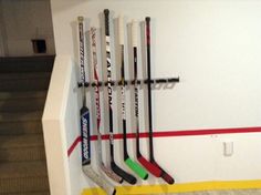 there are many hockey sticks hanging on the wall