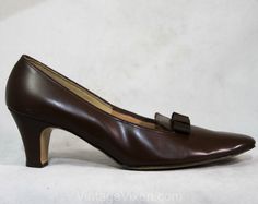 Exquisite mocha brown shoes! These smooth leather pumps have sophisticated crepe bow accents with 2 3/8-inch Louis heels. They have a tapered toe and they're pristine, never worn from late 50s / early 60s deadstock. Size Marked 7 AA / AAAA (AA describes the toebox width, AAAA describes the heel width) Measurements Ball of Foot Width 2 3/4, Toe to Heel Length 10 3/8 Inches Era 1960s Label " Cotillion / Footwear / TM REG US PAT OFF'' stamped in gold to insole Materials Smooth mocha chocolate brown Mocha Chocolate, Chocolate Mocha, Early 60s, Brown Shoes, Mocha Brown, Brown Shoe, Leather Pumps, Womens Heels, Women's Pumps