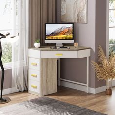 a desk with a computer on it in front of a window and a statue next to it