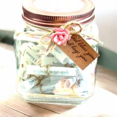 a glass jar filled with lots of candy and some tags on the lid that say happy mother's day