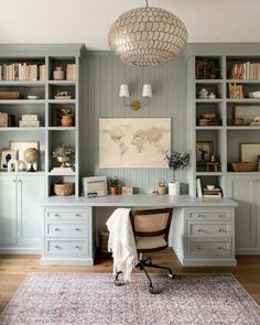 a home office with built in bookcases and a rug