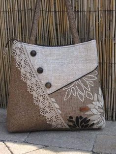 a handbag is sitting on the ground next to a bamboo wall with an intricate design