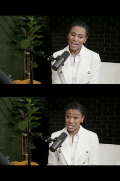 a woman in a white suit talking into a microphone