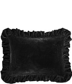 a black velvet pillow with ruffled edges