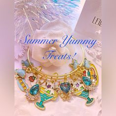 Summer Sweets Gold Charm Bangle Bracelet With : Center Aqua Crystal Teardrop With Gold Trim 2 Ice Cream Sundae In Aqua Colored Dish 2 Aqua Crystal Teardrops With Rhinestone Trim Strawberry Parfait With Yummy Strawberry On Top Fruity Pancakes With White Frosting 2 Aqua Bows With White Polka Dots And Center Rhinestone Free Earrings With Purchase ! Adjustable Sweet Jewelry For Party, Sweet Adjustable Charm Bracelet For Gift, Sweet Adjustable Charm Bracelet As Gift, Sweet Dangle Jewelry, Sweet White Bracelet Jewelry, Strawberry Parfait, Summer Sweets, White Frosting, Resin Bangles