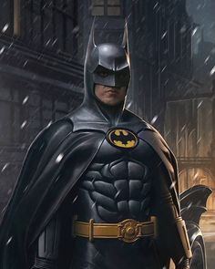 the batman is standing in the snow with his cape open