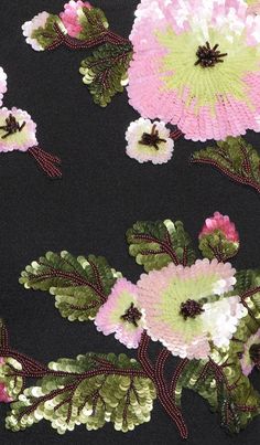 an image of some flowers on a black shirt with green and pink sequins