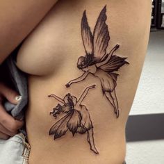 a woman with a tattoo on her stomach is holding onto the side of her breast