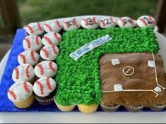 a baseball themed birthday cake with cupcakes in the shape of a field and ball