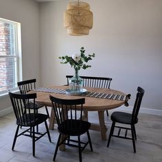 a dining room table with four chairs around it