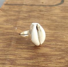 Cowrie Ring, Sterling Silver Shell Ring, Natural Shell Ring, Cowry Kauri Shell, best Ring, cowrie Silver Ring, Boho Yoga Ring, Gift for Her It brings good luck, wealth, prosperity, fame and the power of destiny. Cowry shells are used in some religious or auspicious ceremonies too, like in Laxmi puja cowrie shells are kept to please Goddess Laxmi and be blessed by Her and Lord Vishnu. Handmade White Shell Rings, White Shell-shaped Rings For Beach, White Shell Rings For The Beach, White Shell Rings For Beach, Cowrie Ring, Laxmi Puja, Seashell Ring, Best Ring, Shell Tattoos