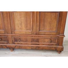 an old wooden armoire sitting on top of a hard wood floor