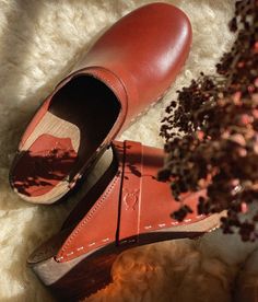 The best clogs for all occasions. Stylish with a nod to the past and an eye towards the future. With a handcrafted design, versatile colors, and comfortable wooden soles, these classic wooden clog mules will last you for years to come. Clog measurements:Heel height: 1 3/4” (4.5 cm)Toe height: 1 5/8″ (4.1 cm)Fit:RegularLeather:Vegetable tanned leatherClogs consist of:Base: European Lime WoodSole: Rubber soleFastening: Staples Clogs Women, Clog Mules, Cork Sandals, Wooden Clogs, Clog Sandals, Womens Clogs, An Eye, Boot Shop, Mule