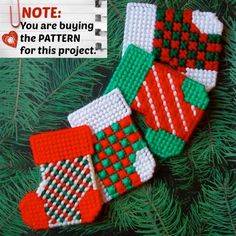 two red and green mittens hanging from a christmas tree with the note you are buying for this project