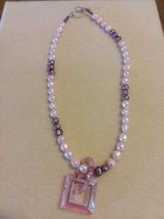 This is a genuine pearl necklace with a crystal pendant. Pearls are pink and purple, the pendant is pink. Genuine Pearl Necklace, Purple Pearl, Real Pearls, Pearl Shell, Beaded Necklaces, Pink And Purple, Crystal Pendant, Chain Styles, Pink Purple