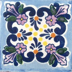 a blue and white tile with flowers on it