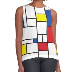 a woman wearing black pants and a white top with multicolored squares on it