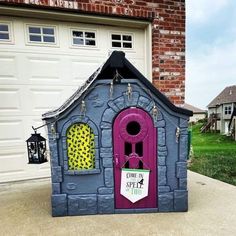 a house made out of cardboard and painted purple