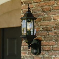 an old fashioned lantern on the side of a brick building