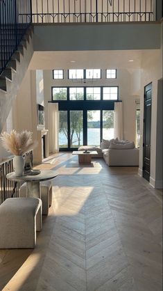 a living room filled with furniture next to a staircase