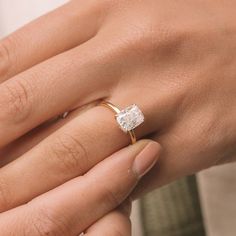 a woman's hand with a diamond ring on it