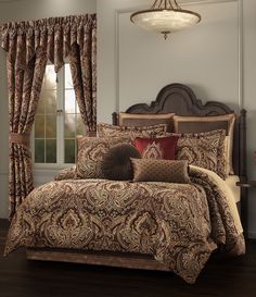 a bed in a room with a brown and red comforter