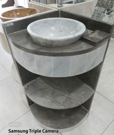 a white sink sitting on top of a marble counter