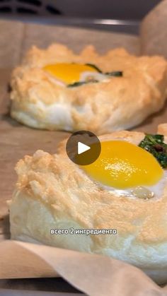 two pastries with an egg on top