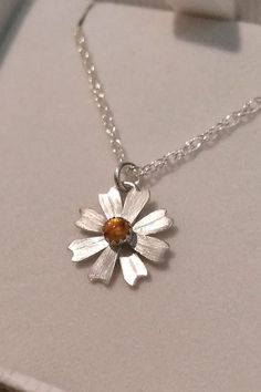 Simple and sweet, this dainty daisy flower necklace glows bright with golden citrine where each petal is hand-sculpted from sterling silver, textured, and soldered together to form this precious hand-crafted necklace. Handmade Sterling Silver Flower Necklace, Dainty Daisy Sterling Silver Jewelry, Hand Forged Amber Sterling Silver Jewelry, Handmade Sterling Silver Petal Jewelry, Silver Daisy Jewelry Gift, Silver Daisy Jewelry For Gift, Dainty Daisy Silver Jewelry, Sterling Silver Flower Birthstone Necklaces, Sterling Silver Flower Birthstone Necklace