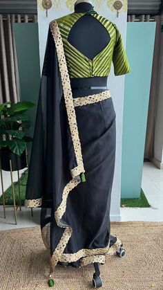 Product Descriptions : Black soft organza saree with golden rich cutwork border is paired up with olive silk banarasi blouse. This ensemble is perfect for special occasions, offering an elegant look without sacrificing comfort. The organza material is lightweight and breathable, while the rich cutwork border adds a subtle yet stunning detail. View this post on Instagram A post shared by Shobana_Nithin_Threads (@threadslabel_india) Black Organza Saree, Soft Organza Saree, Banarasi Blouse, Dress Flats, Organza Saree, Cut Work, Affordable Luxury, Saree Blouse, Instagram A