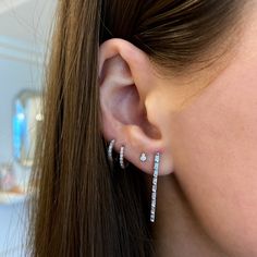 Who knew that a simple, clean line could be so high impact? Our Sadie Pearl Baguette Vertical Bar Drop Earrings are sleek, subtle, and punctuated with alluring sparkle. These diamond drop earrings balance sophisticated elegance and modern edginess, creating a vibe that's fresh and versatile. They exude soft glamour when worn alone yet hold the power to make an ear stack pop. In fact, they'd look lovely paired with our Sadie Pearl Double Baguette Studs for a dazzling, harmonious look! 14 Karat Gold 0.49 Diamond Carat Weight 8.7mm in length and 2.0mm in Width Diamonds are G/H Color and SI Clarity Post with Friction Back Baguette Studs, Dana Rebecca Designs, Vertical Bar, Kids Bracelets, Buddha Pendant, Ear Stack, Bridal Engagement Rings, Climber Earrings, Solitaire Studs