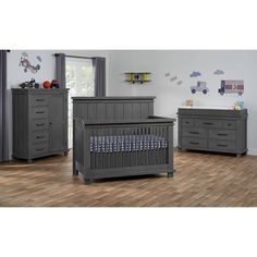 a baby's room with two dressers, a crib and a bed